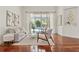 Sunlit living room boasts hardwood floors, modern decor, and a tranquil view of the pool at 2901 Laurel Meadow Ct, Plant City, FL 33566