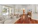 Open-concept living area features hardwood floors and seamless access to outdoor patio and pool at 2901 Laurel Meadow Ct, Plant City, FL 33566