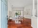 Bright living room featuring hardwood floors and sliding glass doors that look out onto the pool at 2901 Laurel Meadow Ct, Plant City, FL 33566