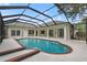 Stunning pool area with a screened enclosure, patio, and views of the home's exterior at 2901 Laurel Meadow Ct, Plant City, FL 33566