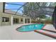 Beautiful pool with steps and brick coping surrounded by a screened enclosure and patio at 2901 Laurel Meadow Ct, Plant City, FL 33566