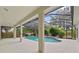 Gorgeous screened-in pool with deck area, surrounded by green trees and lush landscaping at 2901 Laurel Meadow Ct, Plant City, FL 33566