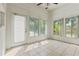 Bright sun room featuring multiple windows, tile flooring and a door leading to the outside at 2901 Laurel Meadow Ct, Plant City, FL 33566