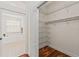 Spacious walk-in closet featuring shelving, wooden floors and proximity to the bathroom at 2901 Laurel Meadow Ct, Plant City, FL 33566
