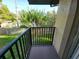 Balcony view showcasing a lush green yard and mature trees, offering a serene outdoor experience at 2935 Lichen Ln # D, Clearwater, FL 33760