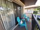 Cozy outdoor balcony featuring two blue Adirondack chairs and sliding glass door access at 2935 Lichen Ln # D, Clearwater, FL 33760