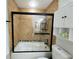 Modern black framed shower with decorative tiling and convenient storage shelves at 2935 Lichen Ln # D, Clearwater, FL 33760