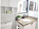 Bathroom vanity features a granite countertop, modern sink faucet and mirror at 2935 Lichen Ln # D, Clearwater, FL 33760