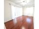 Bright bedroom with hardwood floors, ceiling fan, and sliding glass door to the outside at 2935 Lichen Ln # D, Clearwater, FL 33760