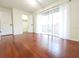 Bedroom featuring hardwood floors, a ceiling fan, and sliding glass doors for balcony access at 2935 Lichen Ln # D, Clearwater, FL 33760