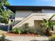 Charming condo featuring private entrance staircase, exterior storage, and verdant landscaping at 2935 Lichen Ln # D, Clearwater, FL 33760