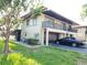 Condo with ground level garage, balcony, and well-maintained lawn at 2935 Lichen Ln # D, Clearwater, FL 33760