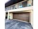 Attached home garage with a brown door and exterior hose at 2935 Lichen Ln # D, Clearwater, FL 33760
