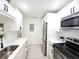 Bright kitchen features white cabinets, stainless steel appliances, and sleek countertops at 2935 Lichen Ln # D, Clearwater, FL 33760