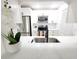 Modern kitchen featuring white cabinets, stainless steel appliances, and quartz countertops at 2935 Lichen Ln # D, Clearwater, FL 33760