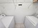 Practical laundry area equipped with a side-by-side washer and dryer and wire shelving at 2935 Lichen Ln # D, Clearwater, FL 33760