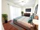 Comfortable primary bedroom featuring wood floors, ample lighting, and a ceiling fan at 2935 Lichen Ln # D, Clearwater, FL 33760