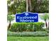 Eastwood Shores community sign surrounded by lush landscaping and a white picket fence at 2935 Lichen Ln # D, Clearwater, FL 33760