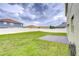 Spacious fenced backyard with lush grass and a concrete patio, perfect for outdoor entertaining at 3012 Magnolia Meadows Dr, Plant City, FL 33567