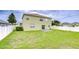 Large backyard featuring a well-maintained lawn and a white privacy fence at 3012 Magnolia Meadows Dr, Plant City, FL 33567