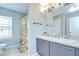 Bathroom featuring double sinks and a shower and toilet behind a decorative curtain at 3012 Magnolia Meadows Dr, Plant City, FL 33567