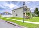 Two-story home with manicured lawn, palm trees, and a sidewalk at 3012 Magnolia Meadows Dr, Plant City, FL 33567