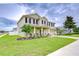 Charming two-story home with a well-manicured lawn and lush landscaping at 3012 Magnolia Meadows Dr, Plant City, FL 33567