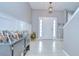Welcoming foyer with tiled flooring, decorative lighting, and paneled walls at 3012 Magnolia Meadows Dr, Plant City, FL 33567