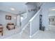 Light-filled foyer featuring a staircase, a sliding barn door to a den, and neutral paint tones at 3012 Magnolia Meadows Dr, Plant City, FL 33567