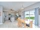 Bright eat-in kitchen featuring gray cabinets, stainless appliances, and a sliding door to the backyard at 3012 Magnolia Meadows Dr, Plant City, FL 33567