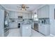 Modern kitchen with gray cabinets, stainless steel appliances, and a mosaic tile backsplash at 3012 Magnolia Meadows Dr, Plant City, FL 33567