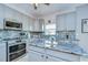 Beautiful kitchen with gray cabinets, granite countertops, and stainless-steel appliances at 3012 Magnolia Meadows Dr, Plant City, FL 33567