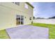 View of the gray tiled patio area with sliding glass door to the home's interior at 3012 Magnolia Meadows Dr, Plant City, FL 33567