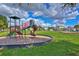 Community playground includes colorful play structures, green space, and mulched area for safe playing at 3012 Magnolia Meadows Dr, Plant City, FL 33567