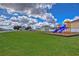 Community playground featuring slides and a large, well-maintained grassy area perfect for outdoor activities at 3012 Magnolia Meadows Dr, Plant City, FL 33567