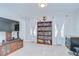 Bright sitting area adjacent to the main bedroom features a bookcase and neutral walls at 3012 Magnolia Meadows Dr, Plant City, FL 33567