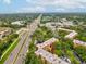 Aerial view of condo building with red arrow, water feature, highway and stores in the background at 3062 Eastland Blvd # 405, Clearwater, FL 33761