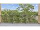 Balcony overlooking a lush green space with a view of mature trees and blue skies at 3062 Eastland Blvd # 405, Clearwater, FL 33761