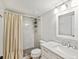 Bathroom featuring modern vanity and shower with marble-look tile at 3062 Eastland Blvd # 405, Clearwater, FL 33761