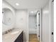 Bright bathroom featuring a granite-topped vanity and a shower with modern tile at 3062 Eastland Blvd # 405, Clearwater, FL 33761