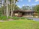A view of the clubhouse exterior featuring a porte cochere and lush landscaping at 3062 Eastland Blvd # 405, Clearwater, FL 33761