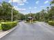 A circular driveway with a guardhouse at the entrance to the property with manicured landscaping at 3062 Eastland Blvd # 405, Clearwater, FL 33761
