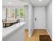 Bright entryway featuring wood floors, a modern front door, and a view of the dining area and windows at 3062 Eastland Blvd # 405, Clearwater, FL 33761