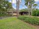 Single-story home featuring a carport, lush landscaping, and a well-manicured lawn at 3062 Eastland Blvd # 405, Clearwater, FL 33761