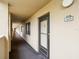 Condo front door with black trim and unit number with hallway view at 3062 Eastland Blvd # 405, Clearwater, FL 33761