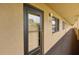 Condo front door with black trim and unit number with hallway and outside view at 3062 Eastland Blvd # 405, Clearwater, FL 33761