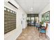 Condo hallway features tile floors, mailboxes, elevator, and seating area at 3062 Eastland Blvd # 405, Clearwater, FL 33761
