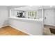 Kitchen area featuring white cabinetry and a breakfast bar at 3062 Eastland Blvd # 405, Clearwater, FL 33761