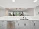 Modern kitchen showcasing an open layout with bar seating and a view of the bright and airy living room at 3062 Eastland Blvd # 405, Clearwater, FL 33761
