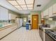 A commercial kitchen featuring stainless steel appliances, tile flooring and ample counter space at 3062 Eastland Blvd # 405, Clearwater, FL 33761